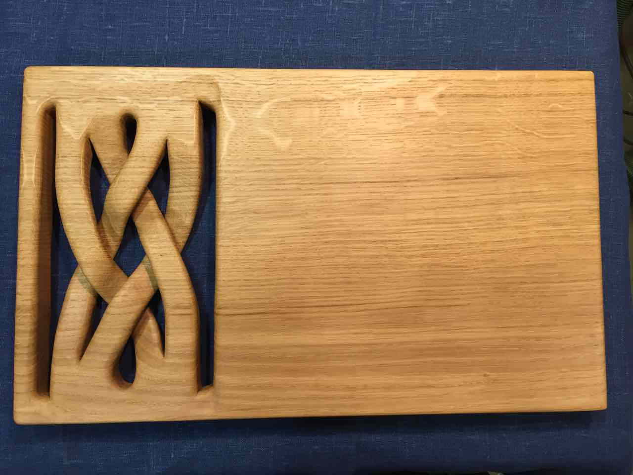 Cutting board with carved braid